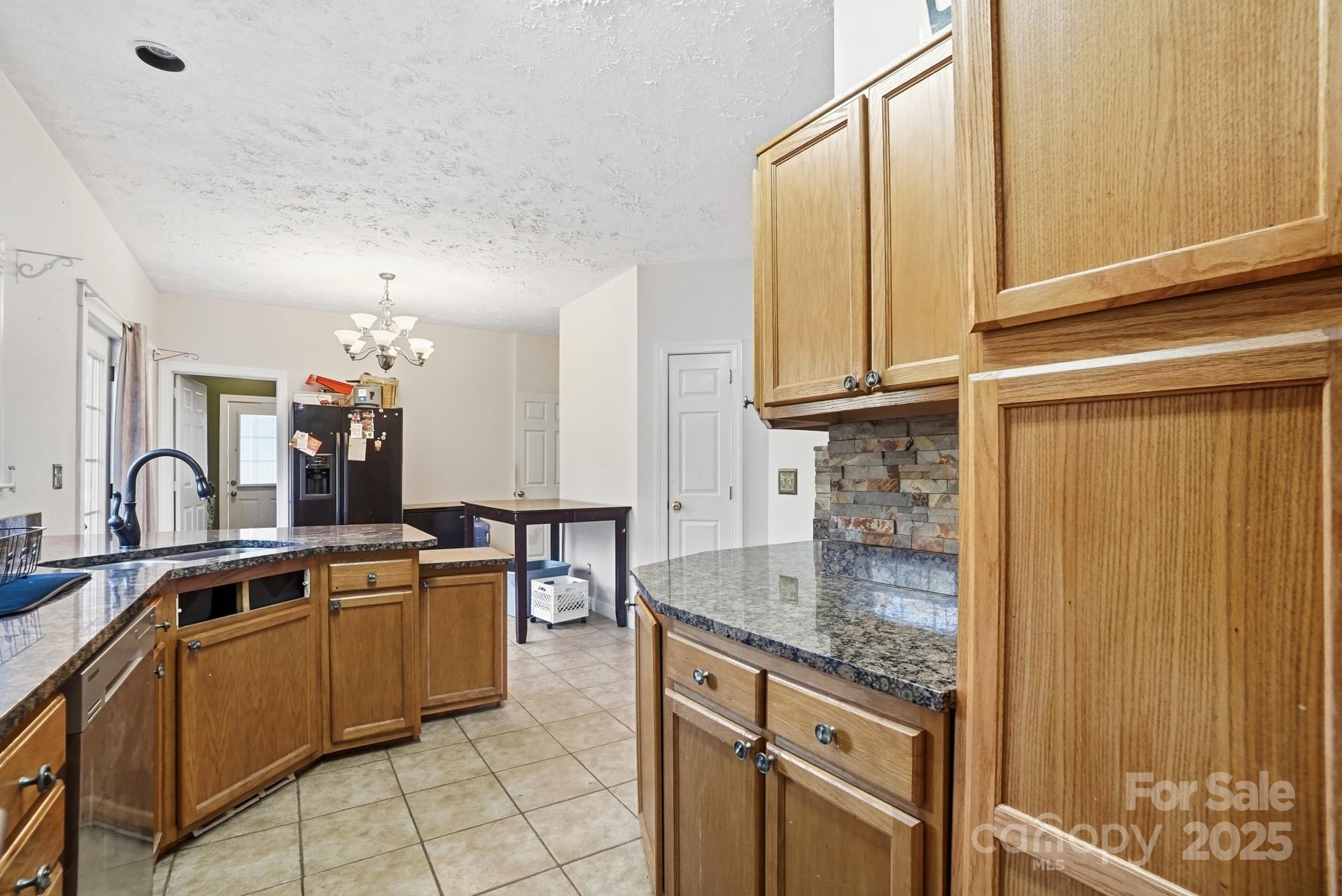 218 Fulbright Road Stony Point, NC 28678 - Photo 12 of 47 a kitchen with stainless steel appliances granite countertop a sink and cabinets