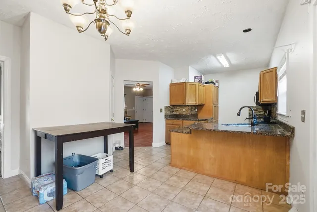 a kitchen with stainless steel appliances a sink cabinets and wooden floor
