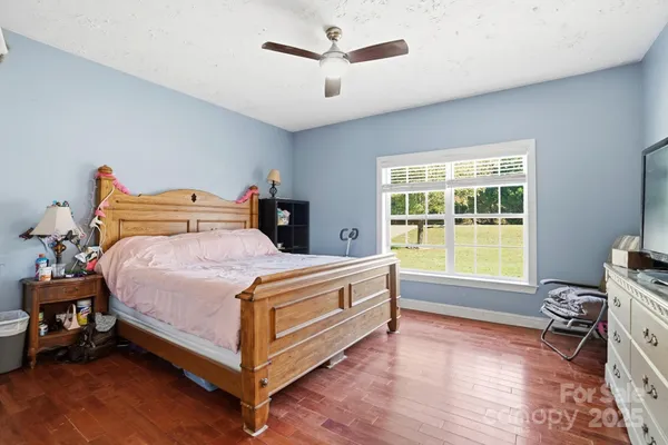 a bed room with a bed and a chair