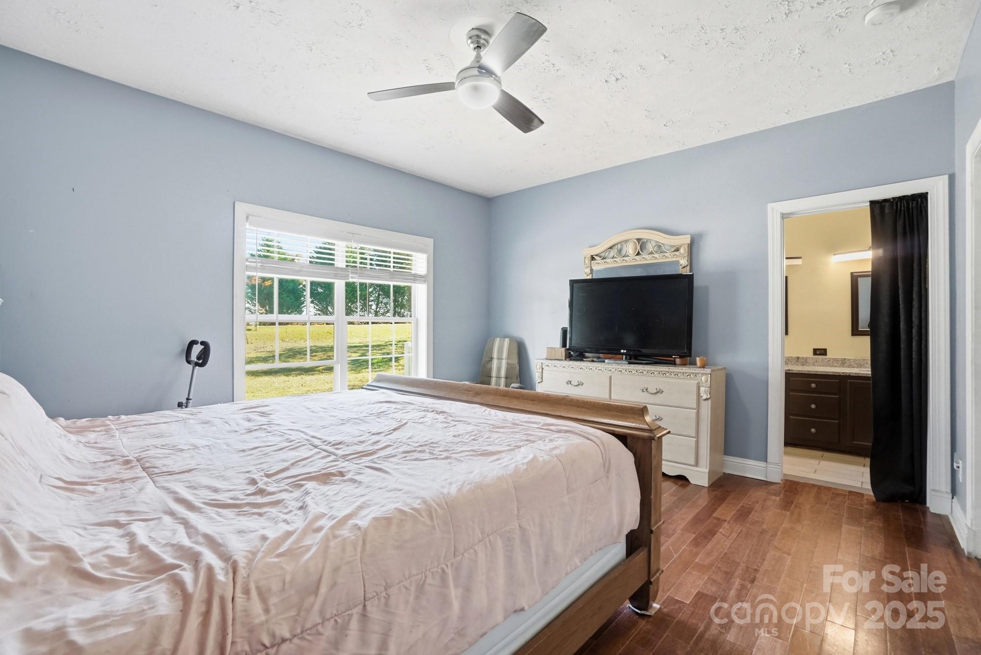 218 Fulbright Road Stony Point, NC 28678 - Photo 15 of 47 a bedroom with a bed and a flat screen tv
