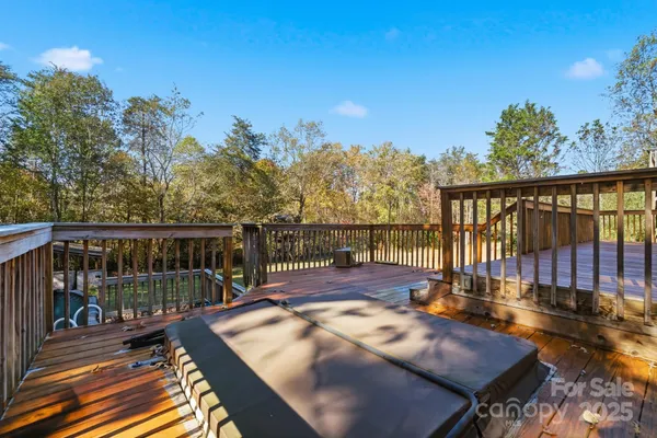 a view of a balcony with wooden floor and outdoor seating