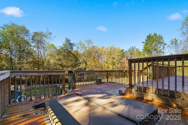 a balcony with wooden floor table and chairs