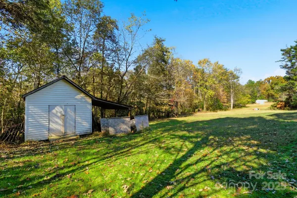 a view of a backyard with large trees