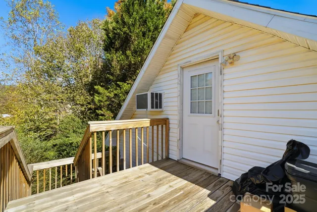 a view of a wooden deck and a backyard