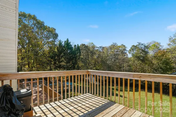 a view of balcony with wooden floor and fence