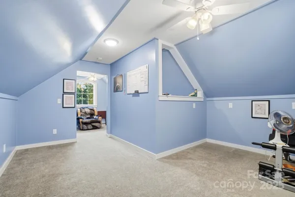 a view of a livingroom with furniture and a ceiling fan