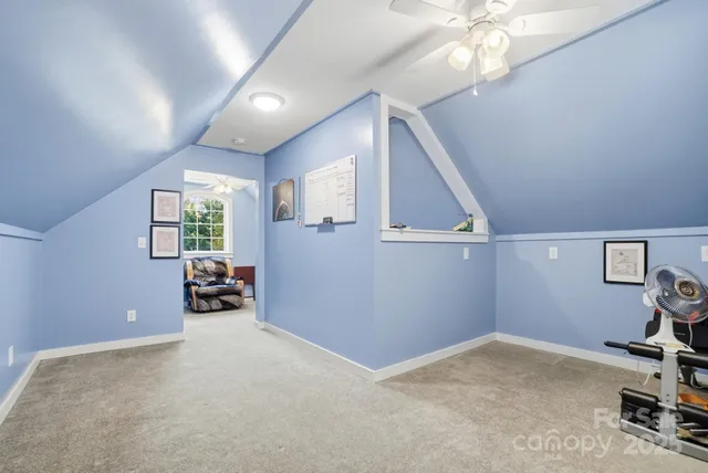 a view of a livingroom with furniture and a ceiling fan