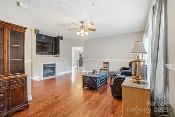 a living room with furniture fireplace and flat screen tv