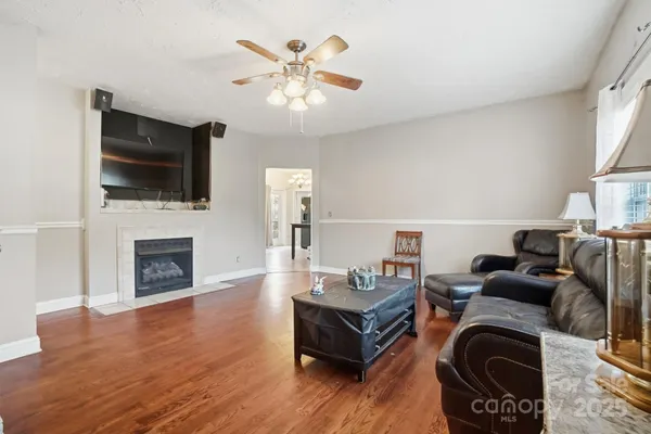 a living room with furniture a fireplace and a flat screen tv