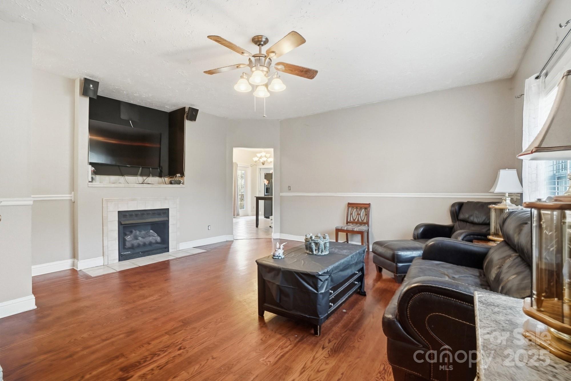 218 Fulbright Road Stony Point, NC 28678 - Photo 7 of 47 a living room with furniture a fireplace and a flat screen tv