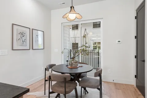 a view of a dining room with furniture window and wooden floor