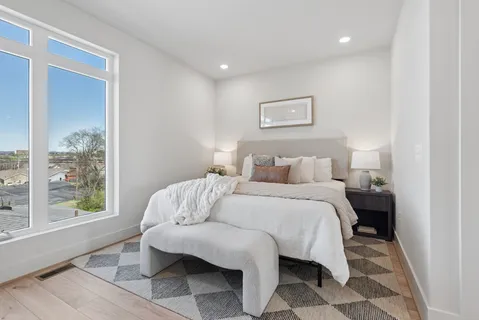 a bedroom with a bed and a window