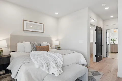 a large white bed in a white room