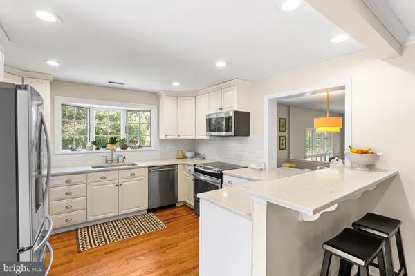 a kitchen with granite countertop a sink stove and refrigerator