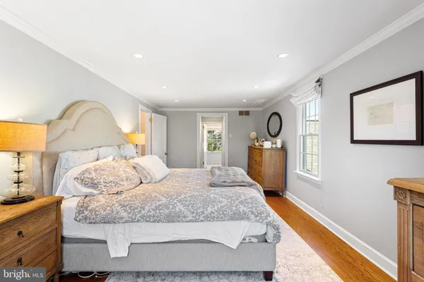 a bedroom with a bed and a dresser in it