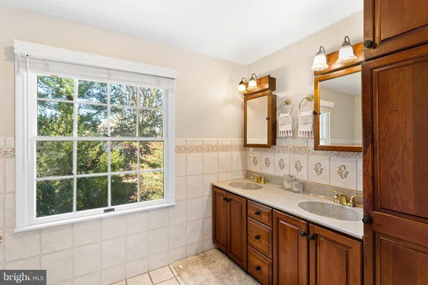 a bathroom with a granite countertop toilet and a shower