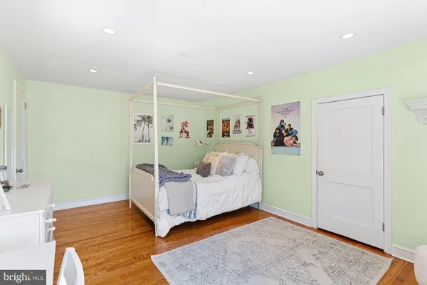 a view of a back room with a window and a refrigerator