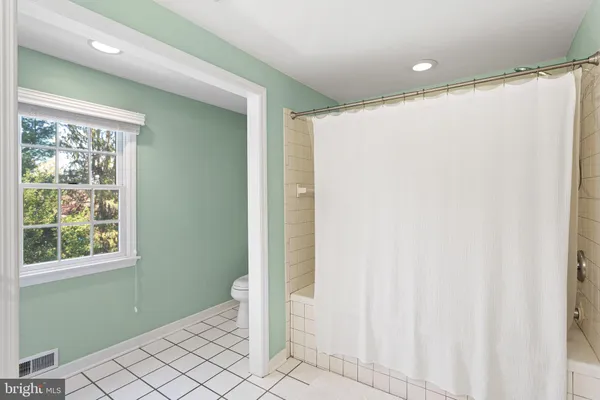 a spacious bathroom with a double vanity sink a mirror and shower