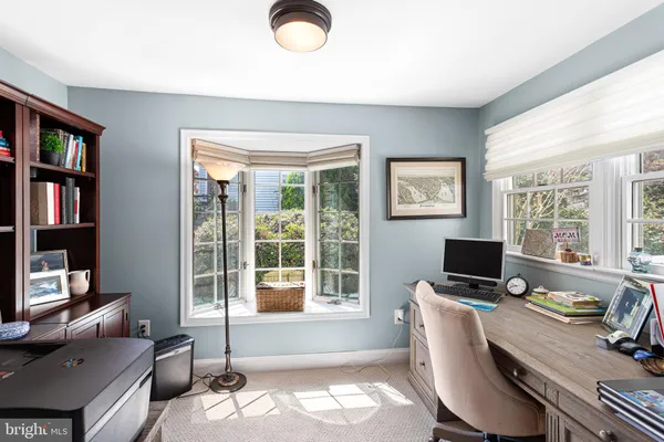 a workspace with furniture and a window