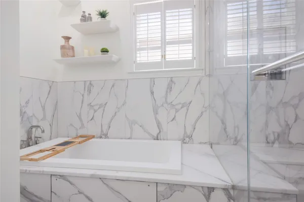 a bathroom with a bathtub and a shower