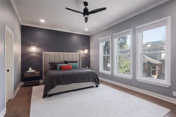 a bedroom with a large bed and a window