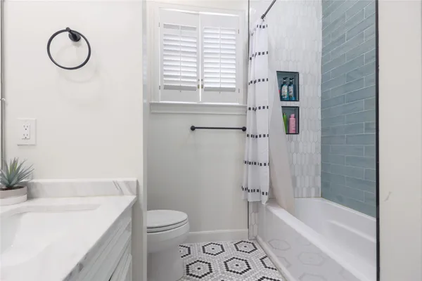 a bathroom with a sink a toilet and a bathtub