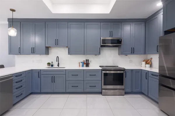 a kitchen with stainless steel appliances granite countertop a stove and a refrigerator