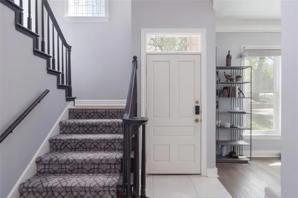 a view of staircase with white walls and windows