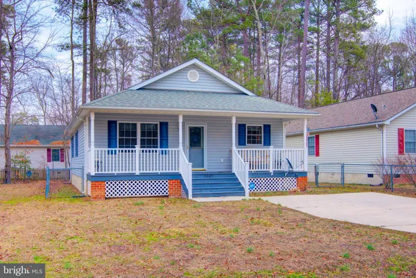 a front view of a house with a yard outdoor seating and barbeque oven