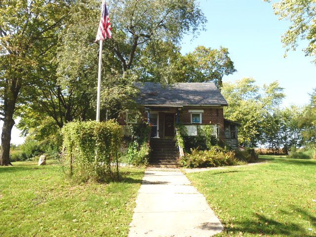 a front view of house with yard and green space