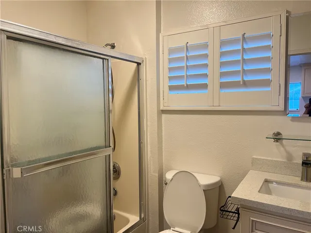 a bathroom with a granite countertop sink and a vanity