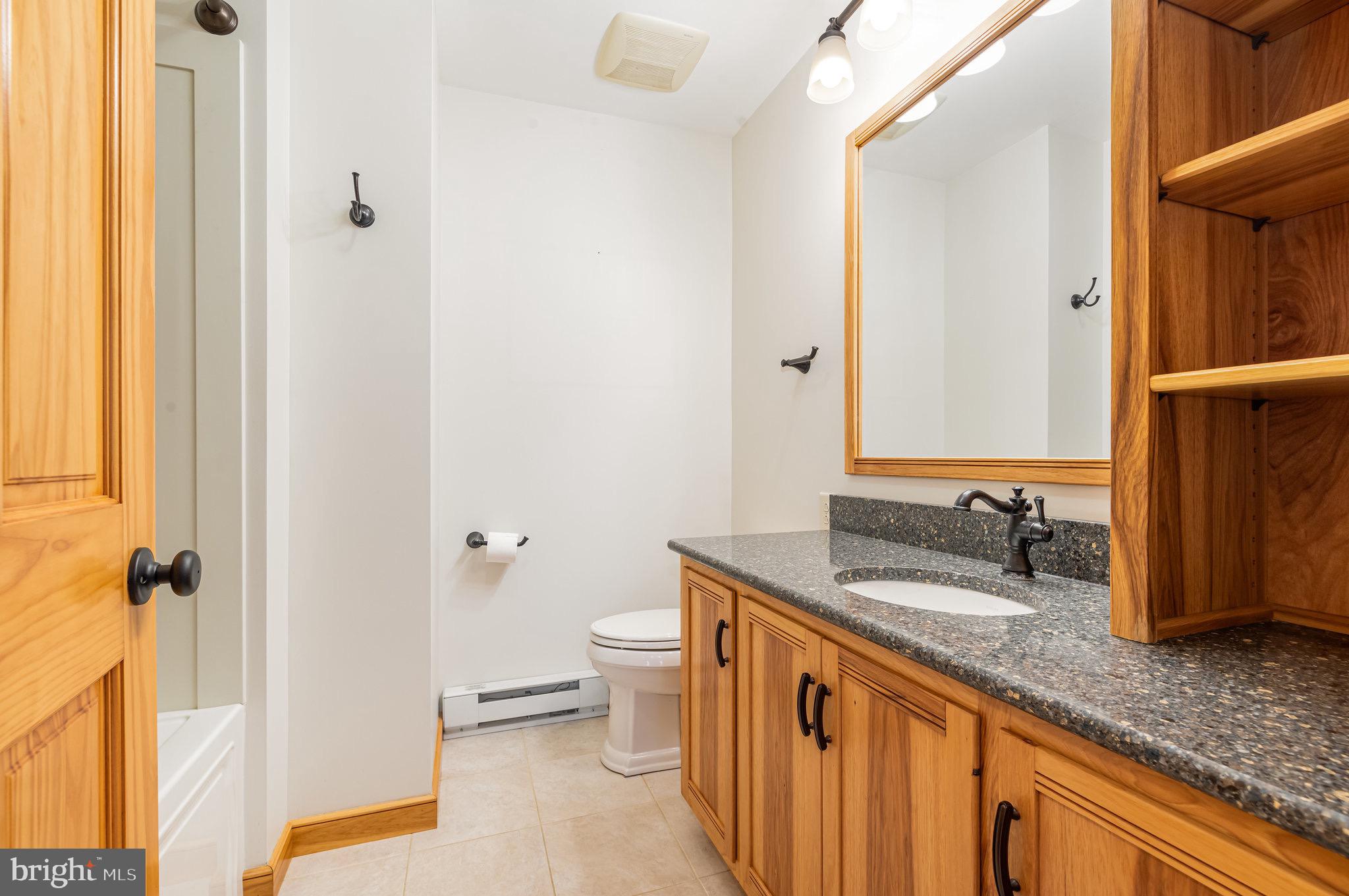 2091 Stumpstown Road Mechanicsburg, PA 17055 - Photo 21 of 52 a bathroom with a granite countertop sink and a mirror