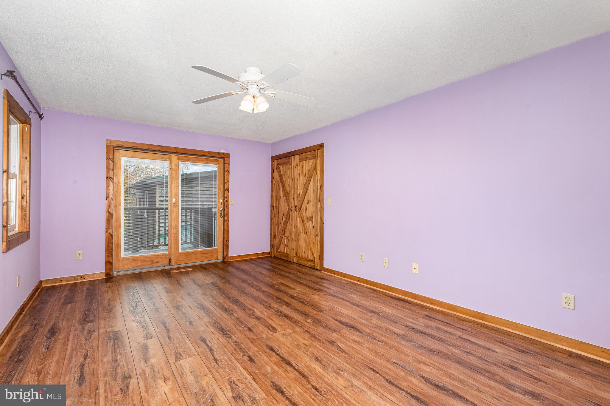 2091 Stumpstown Road Mechanicsburg, PA 17055 - Photo 22 of 52 a view of an empty room with wooden floor and a window