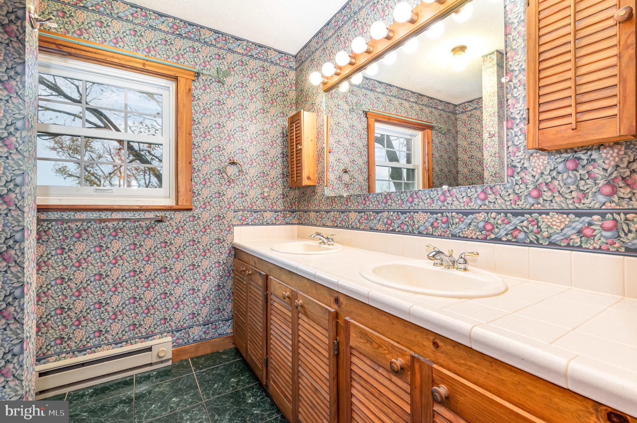 2091 Stumpstown Road Mechanicsburg, PA 17055 - Photo 26 of 52 a bathroom with a sink a vanity and a large mirror