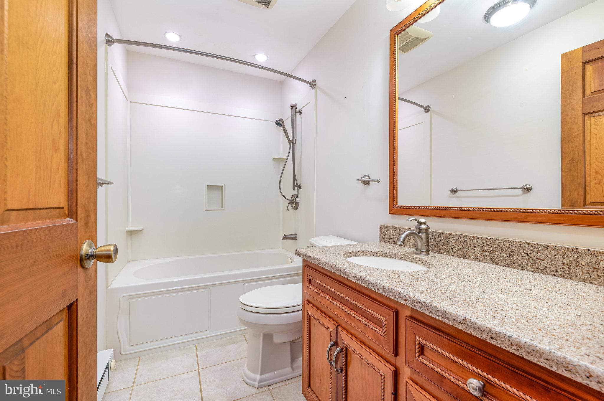 2091 Stumpstown Road Mechanicsburg, PA 17055 - Photo 31 of 52 a bathroom with a granite countertop sink a toilet and shower