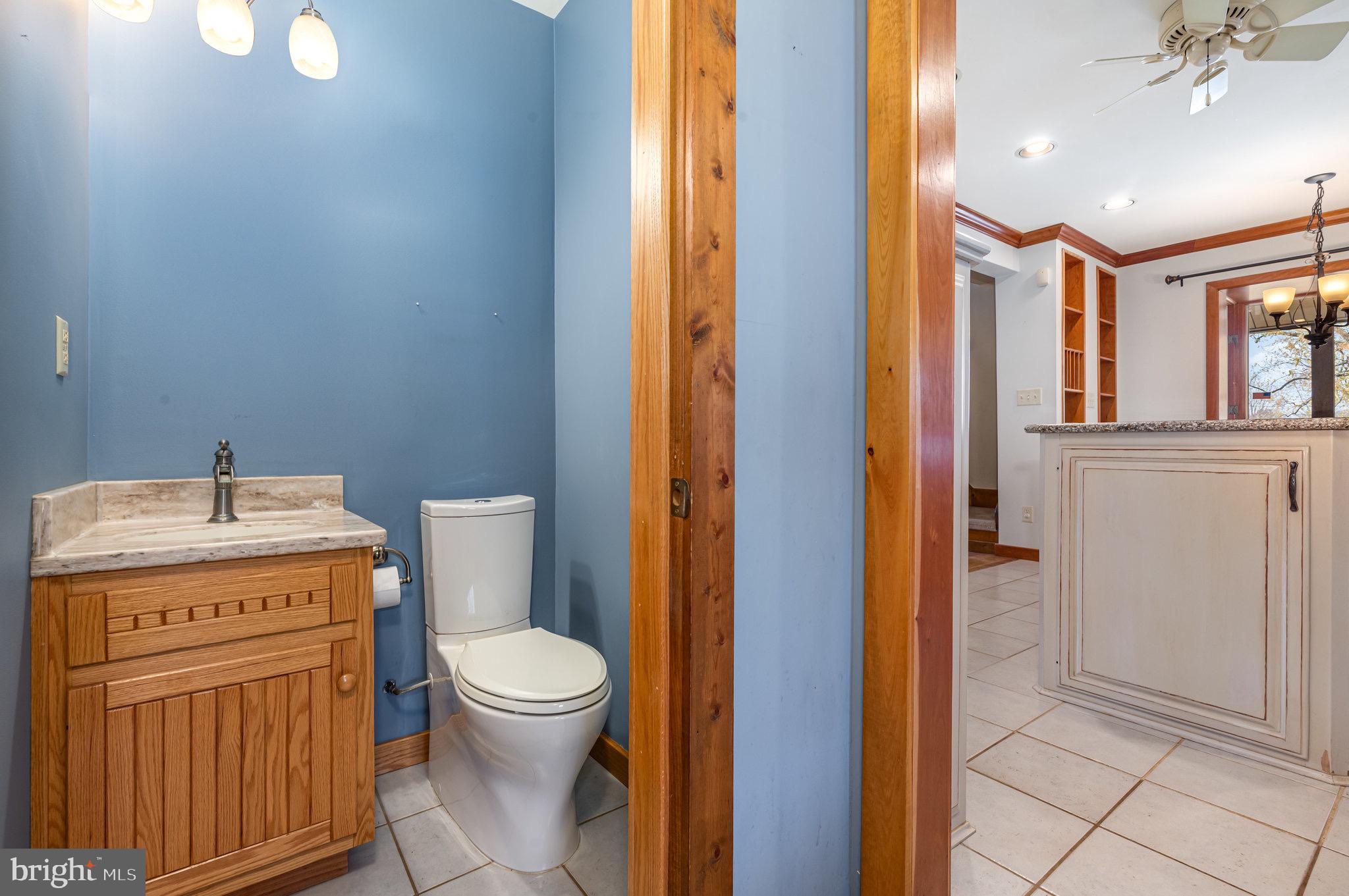 2091 Stumpstown Road Mechanicsburg, PA 17055 - Photo 33 of 52 a bathroom with a granite countertop toilet a sink and a mirror