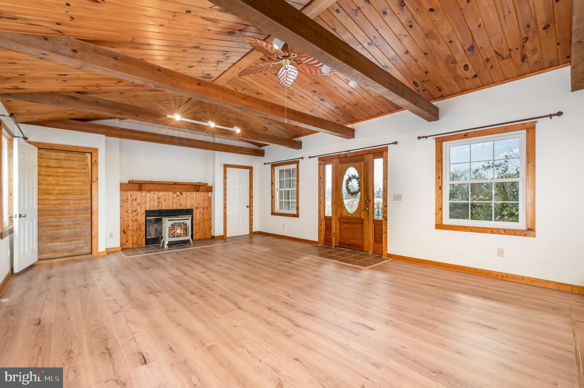 2091 Stumpstown Road Mechanicsburg, PA 17055 - Photo 5 of 52 a view of an empty room with a fireplace and a window