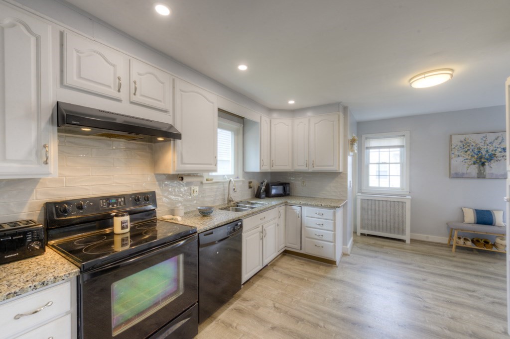 291 Beverly Road Worcester, MA 01605 - Photo 16 of 42 a kitchen with a stove a sink and a microwave
