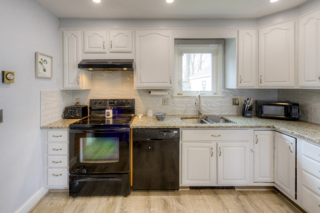 291 Beverly Road Worcester, MA 01605 - Photo 18 of 42 a kitchen with stainless steel appliances granite countertop a stove and a white cabinets