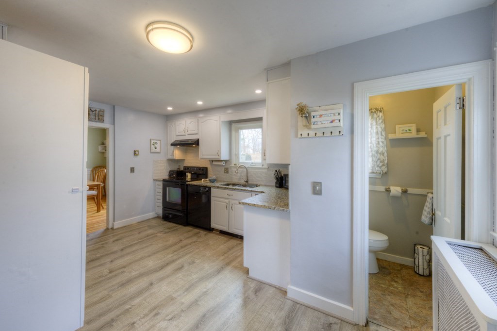 291 Beverly Road Worcester, MA 01605 - Photo 19 of 42 a kitchen with a refrigerator and a stove top oven