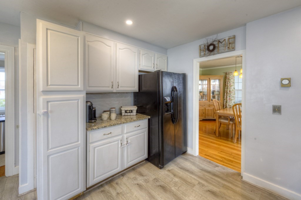 291 Beverly Road Worcester, MA 01605 - Photo 21 of 42 a kitchen with white cabinets and refrigerator