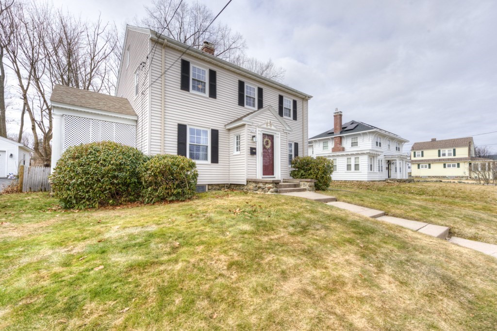 291 Beverly Road Worcester, MA 01605 - Photo 3 of 42 a front view of a house with a yard and garage