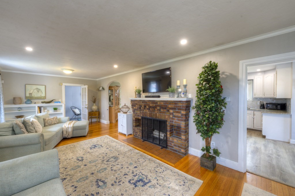 291 Beverly Road Worcester, MA 01605 - Photo 5 of 42 a living room with furniture and a fireplace