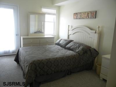 1301 West Avenue, Unit B Ocean City, NJ 08226 - Photo 7 of 11 a bedroom with a bed and window