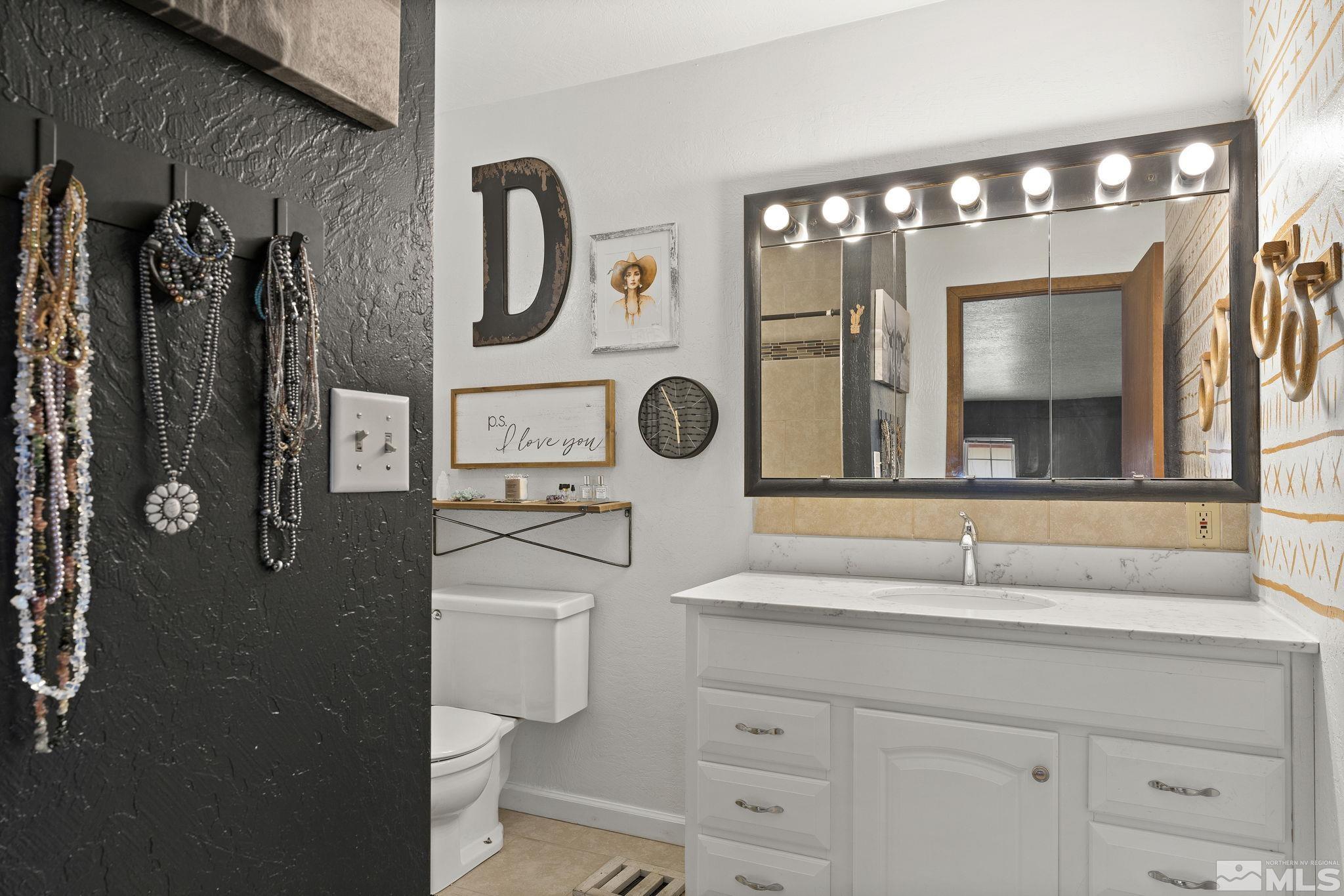 2375 Rice Road Fallon, NV 89406 - Photo 18 of 39 a bathroom with a sink a toilet and mirror