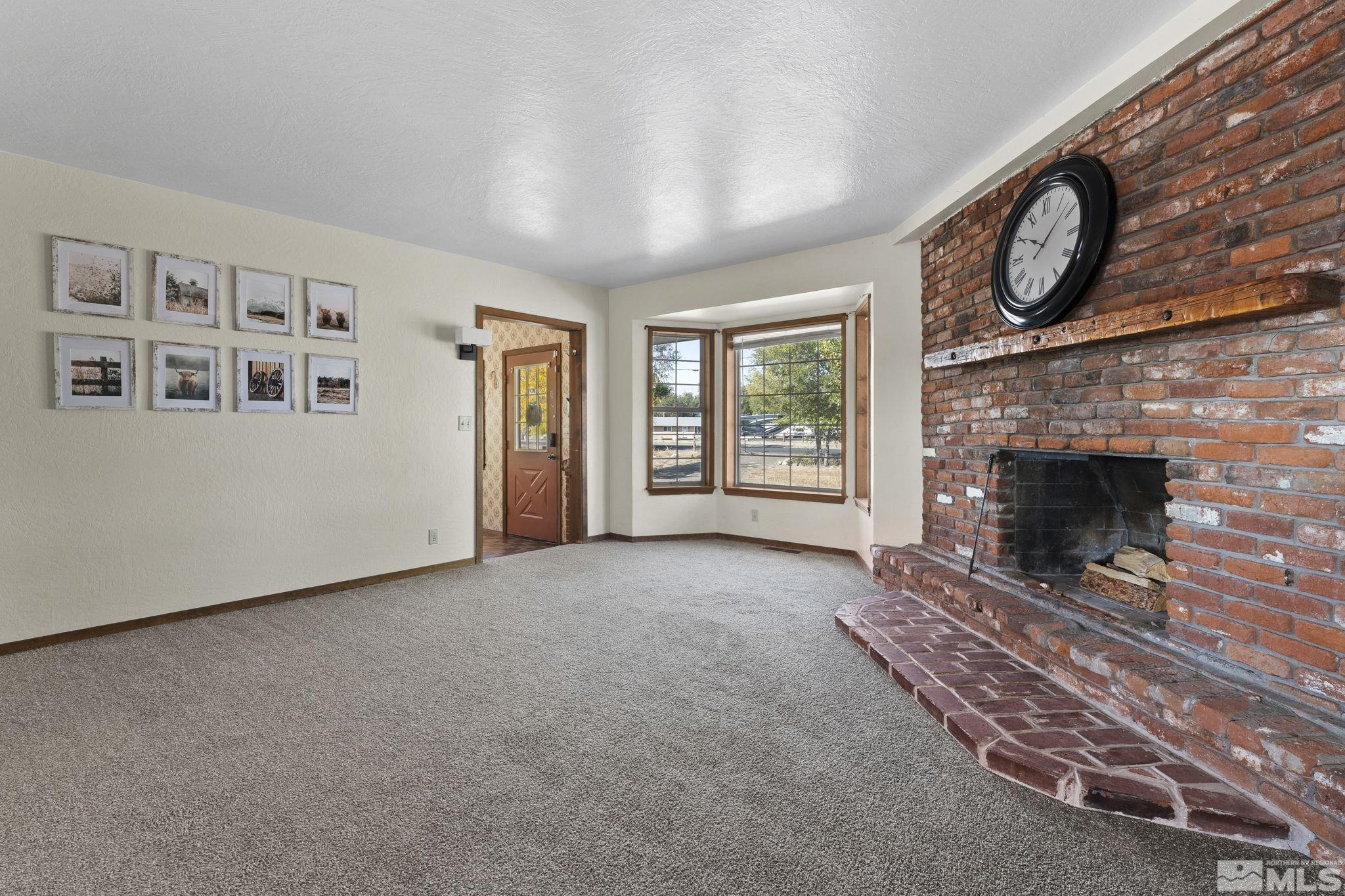 2375 Rice Road Fallon, NV 89406 - Photo 4 of 39 a view of an empty room with a fireplace and a window