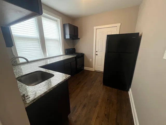 a kitchen with a refrigerator and a sink