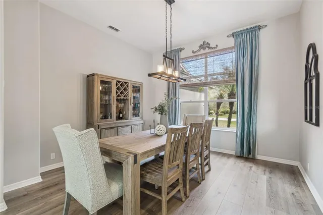 a kitchen with stainless steel appliances kitchen island granite countertop a refrigerator a stove and a sink