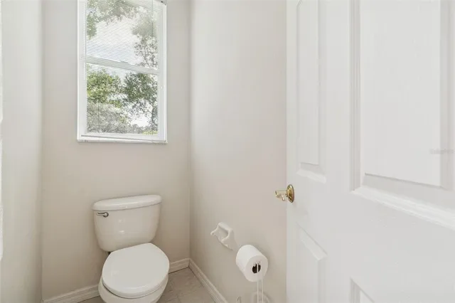 a living room with furniture a flat screen tv and a chandelier