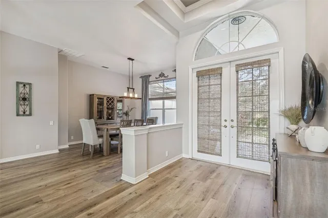 a view of a dining room with furniture wooden floor and chandelier
